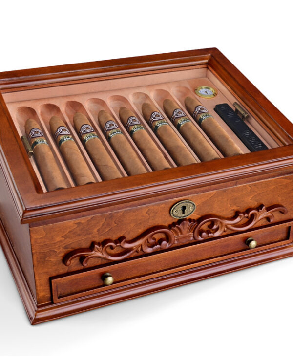 Ornate mahogany cigar humidor with glass top, showing a row of cigars and a small drawer beneath