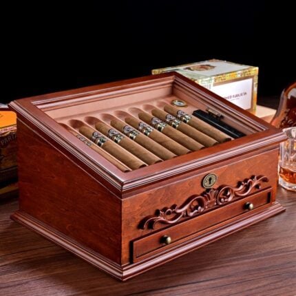 Open rosewood cigar humidor with carved front, cigars and key lock