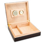 Wooden cigar humidor with open lid showing hygrometer and humidifier on the lid, and divided storage tray inside.