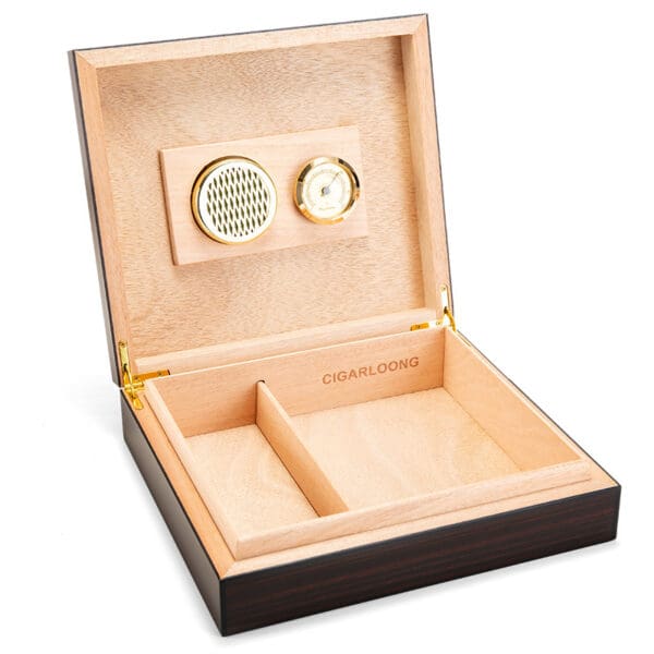 Wooden cigar humidor with open lid showing hygrometer and humidifier on the lid, and divided storage tray inside.
