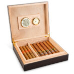 Open wooden cigar humidor with cigars neatly arranged in compartments and a hygrometer on the lid