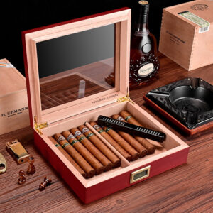 Open wooden cigar humidor filled with cigars, a black lighter rests on the lid, and a hygrometer/display sits inside the case.
