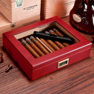 Red wooden cigar humidor opened to reveal cigars inside and a digital hygrometer on the front edge.
