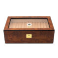 Wooden cigar humidor with a glass top showing lined interior and a small circular humidification device inside, plus a gold lock on the front.
