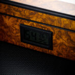 Digital humidity and temperature display embedded in a burl wood panel showing 54% and 26.7°C.