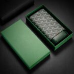 Open green box revealing a patterned wallet with a gray geometric repeating motif and dark leather accents