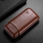 Brown leather wallet-style phone case with a curved flap on a dark surface.