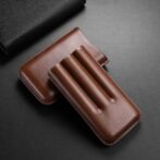 Brown leather case with three rounded slots, likely a pen or tool holder, on a dark surface.