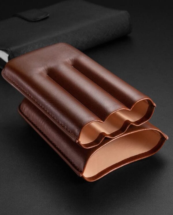CL035-03 Brown leather card holder with three curved pockets on a dark surface, showing a slim wallet design.