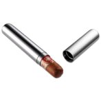 Cigar stored in a sleek silver travel case with the cap off beside it.