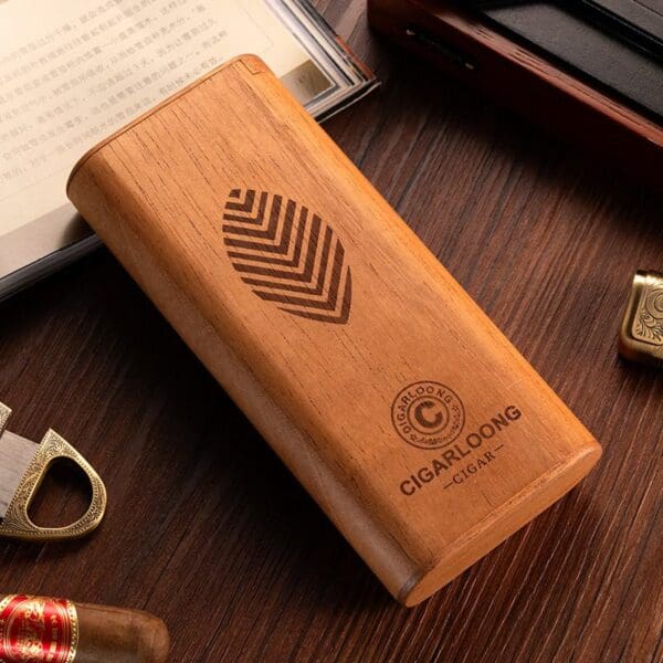CL041-01 Wooden cigar humidor box with a leaf logo and 'CIGARLOONG' branding on a dark wood table surrounded by cigar accessories.