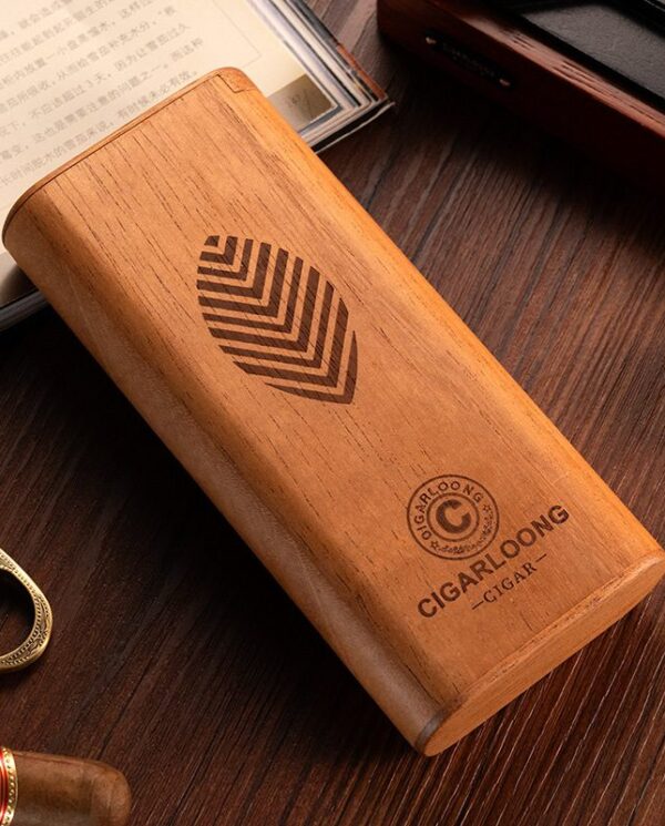 CL041-01 Wooden cigar humidor box with a leaf logo and 'CIGARLOONG' branding on a dark wood table surrounded by cigar accessories.
