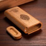 Wooden USB flash drive with its cap removed, revealing the USB connector on a wooden surface.