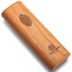 Wooden cylindrical cigar tube with a leaf-pattern emblem and branding stamp near the bottom.