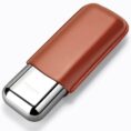 Close-up of a metal lighter wrapped in a brown leather sleeve, diagonally oriented on a white background