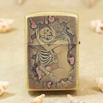 Close-up of the female figure and skull engraving on the polished brass Armor case