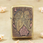 High-polish brass Zippo Armor lighter with engraved beauty, skull and floral artwork