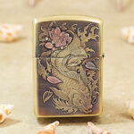 Close-up of the koi-and-dragon engraving on the polished brass Zippo Armor case
