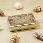 Angled detail of the Koi and Dragon Zippo Armor lighter with flowing engraved lines