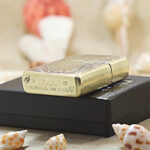 Koi and Dragon brass Zippo Armor lighter displayed with Zippo packaging