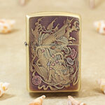 High-polish brass Zippo Armor lighter with engraved koi and dragon artwork