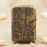 Close-up of the Buddha and grotto-inspired engraving on the brass Zippo Armor case