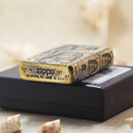 Grotto Buddha brass Zippo Armor lighter displayed with Zippo packaging