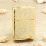 Rear of the golden Zippo with continuous arabesque engraving