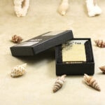 Golden arabesque Zippo displayed in a black Armor presentation box