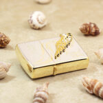 Two-tone Angel Wings lighter lying flat with gold-tone hinge side visible