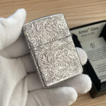 Rear of the silver-tone Zippo with dense scrolling arabesque decoration