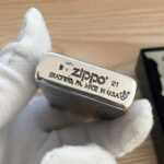 B21 bottom stamp with Armor shield on the silver-tone arabesque Zippo