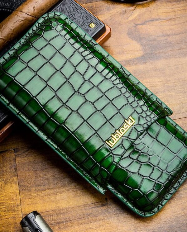 Green crocodile-embossed leather wallet with a gold Urbansky logo on a wooden table surface.