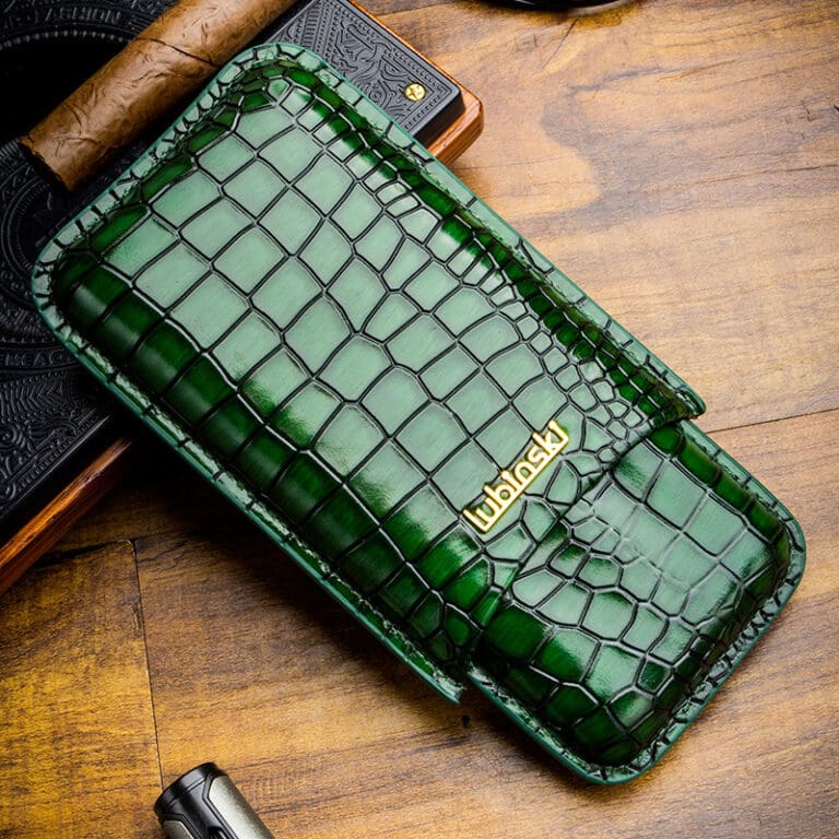 YJA-50015-01 Green crocodile-embossed leather wallet with a gold Urbansky logo on a wooden table surface.
