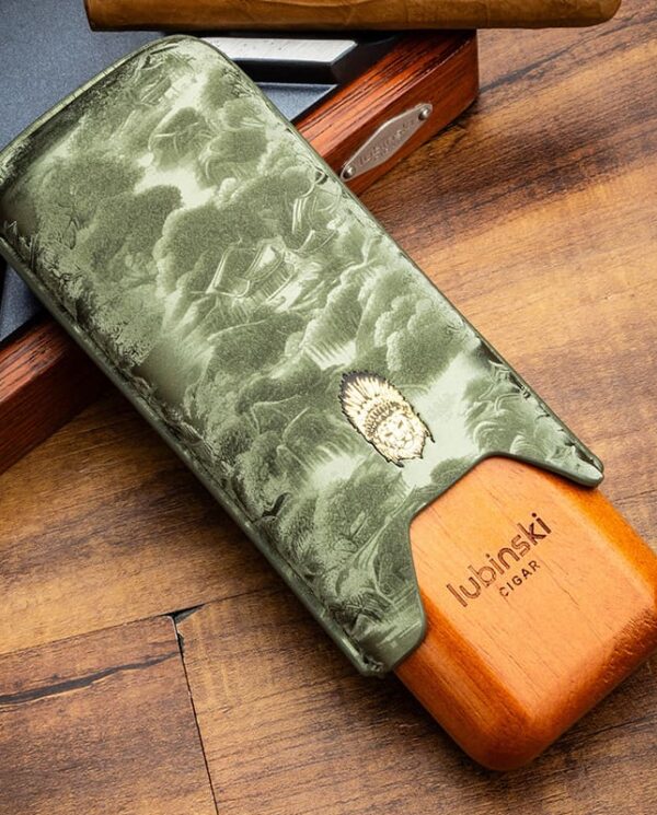 YJA-50029-01 Cigar with a green embossed leather sleeve resting on a wooden surface, Lubinski branding visible on the wood.