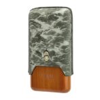 Cigar lighter with a green embossed leather cover over a wooden base stamped with 'Lubinski Cigar'.