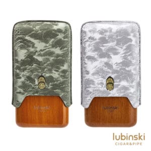 Two Lubinski cigar accessories with leather-textured sleeves (green left, gray right) mounted on wooden bases, shown side by side with the Lubinski Cigar & Pipe logo.