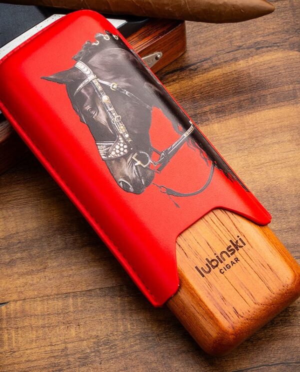 YJA-50031-01 Red leather-wrapped cigar cutter with a horse illustration and wooden Lubinski base, ready for cutting a cigar.