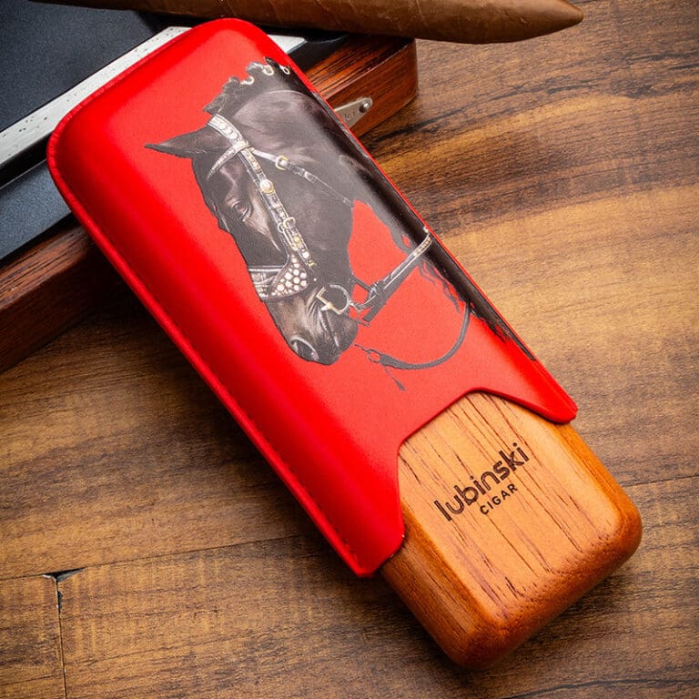 Red leather-wrapped cigar cutter with a horse illustration and wooden Lubinski base, ready for cutting a cigar.