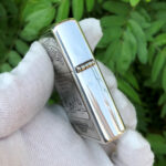 Camel Wides limited-edition sterling silver Zippo lighter – hinge-side view of the polished case and engraved panels