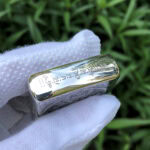 White Tara five-side sterling silver Zippo lighter – top-edge view with engraved Tibetan script