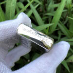 White Tara five-side sterling silver Zippo lighter – top-edge view with Tibetan lettering above the engraved case