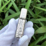 White Tara five-side sterling silver Zippo lighter – narrow-side view of the lotus and cloud motifs