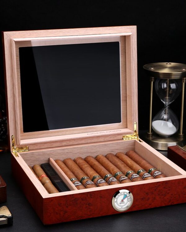 Open wooden cigar humidor revealing a row of cigars and a round humidity gauge on the front panel