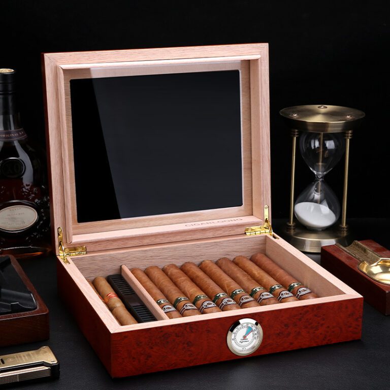 Open wooden cigar humidor revealing a row of cigars and a round humidity gauge on the front panel