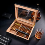 Open carbon fiber cigar humidor with cigars and internal humidifier