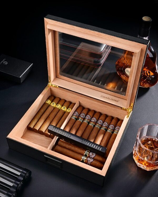 CH025-01 Open wooden cigar humidor showing a row of cigars, some with yellow bands, and a built-in humidifier; whiskey bottle and glass nearby.