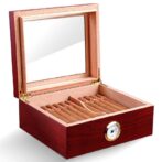Wooden cigar humidor with open lid, rows of cigars inside, and a round hygrometer on the front.
