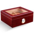 Wooden cigar humidor with glass lid, showing cigars inside and a brass hygrometer on the front.