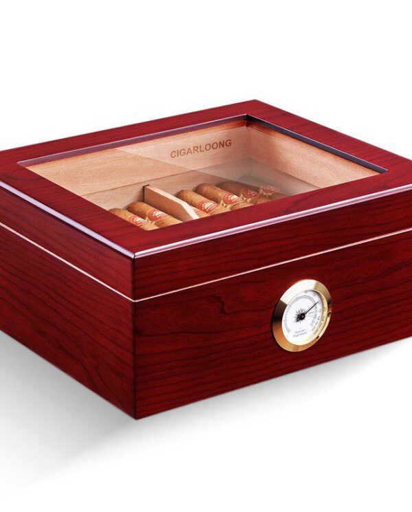 Wooden cigar humidor with glass lid, showing cigars inside and a brass hygrometer on the front.